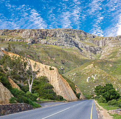 Buy stock photo Landscape view of an empty and quiet road in the mountain for traveling and exploring on getaway vacations during summer. Scenic and secluded street in countryside against a blue sky with copyspace