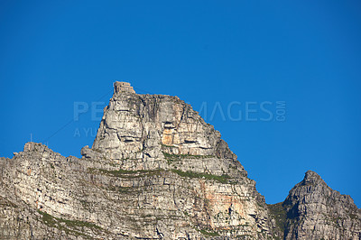 Buy stock photo A mountain cable car station for transporting tourists up Table Mountain, Cape Town to view nature. Low angle of rough, rocky, or dangerous terrain in a remote location with tropical weather