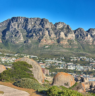 Buy stock photo Scenic view of 12 apostles mountain range overlooking nearby homes in the suburb of Camps bay, Cape Town.
Landscape of relaxing scenic view with rocks and green bushes on a hiking path in summer
