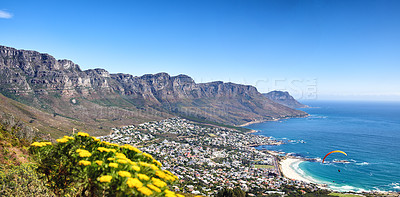 Buy stock photo Landscape of a mountain range near a coastal city against a blue horizon in summer, South African. Wide angle wallpaper of The twelve apostles near calm sea and popular travel location for copy space