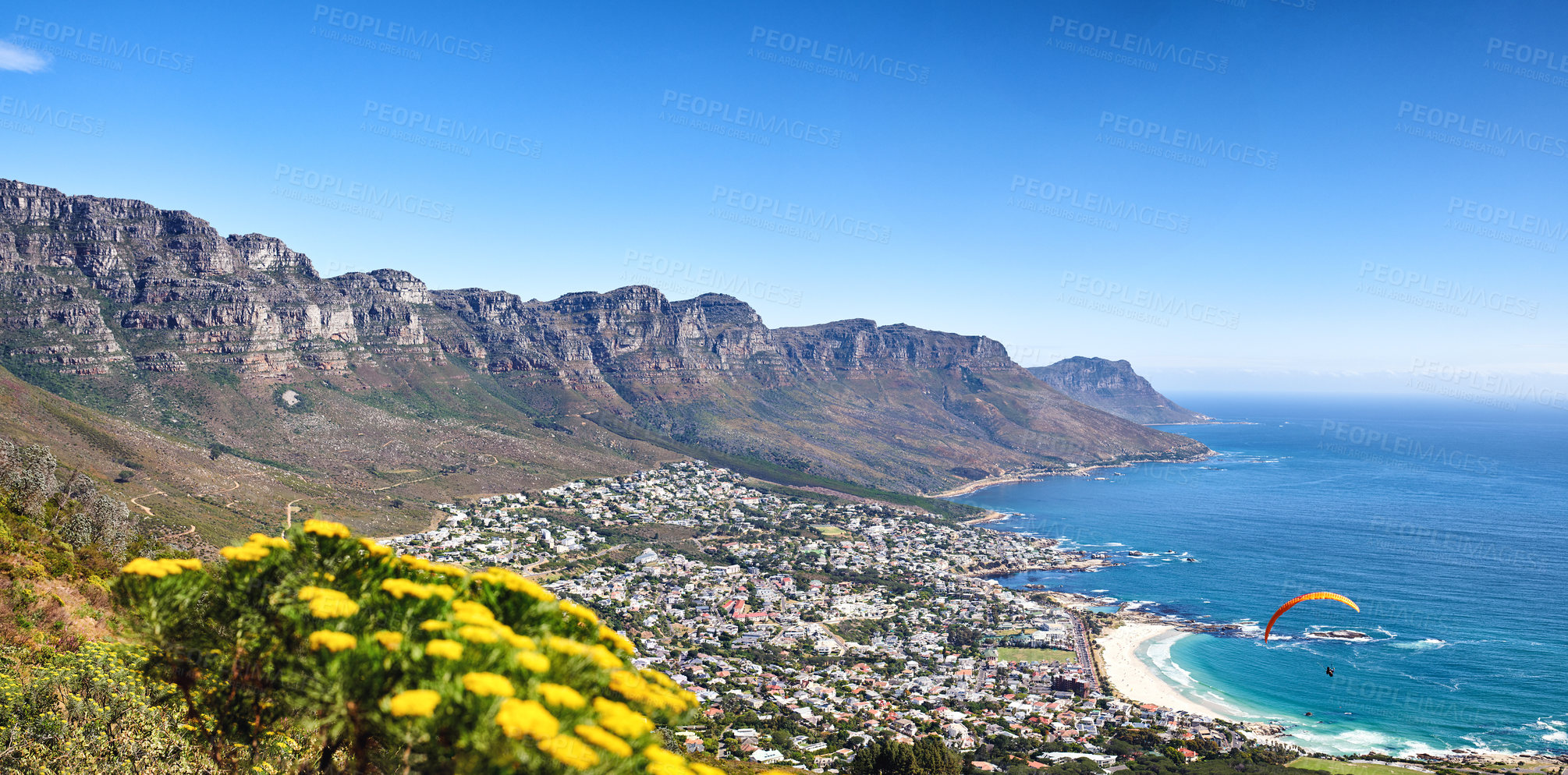 Buy stock photo Landscape of a mountain range near a coastal city against a blue horizon in summer, South African. Wide angle wallpaper of The twelve apostles near calm sea and popular travel location for copy space