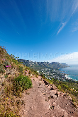 Buy stock photo Landscape, mountains and paraglider flying over sea, city in extreme adrenaline sport or adventure hobby. Copy space, blue sky and ocean view of mountain hiking trail with rocks in travel destination