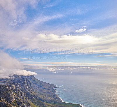 Buy stock photo Panorama of a calm ocean and mountains with a cloudy blue cloudy sky background and copy space. Stunning nature landscape of the sea and horizon against The twelve apostles landmark in Cape Town