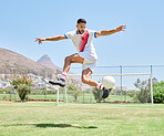 Soccer player field, man soccer ball trick and control outdoor on grass for sports, fitness and health. Jump football skill, young sport athlete and kick freestyle on pitch for wellness in Cape Town
