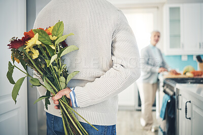 Buy stock photo Senior, couple and flowers for love in home, kitchen or husband with bouquet of roses to surprise woman in happy marriage. Man, wife and back hiding gift, flower and romance together on anniversary