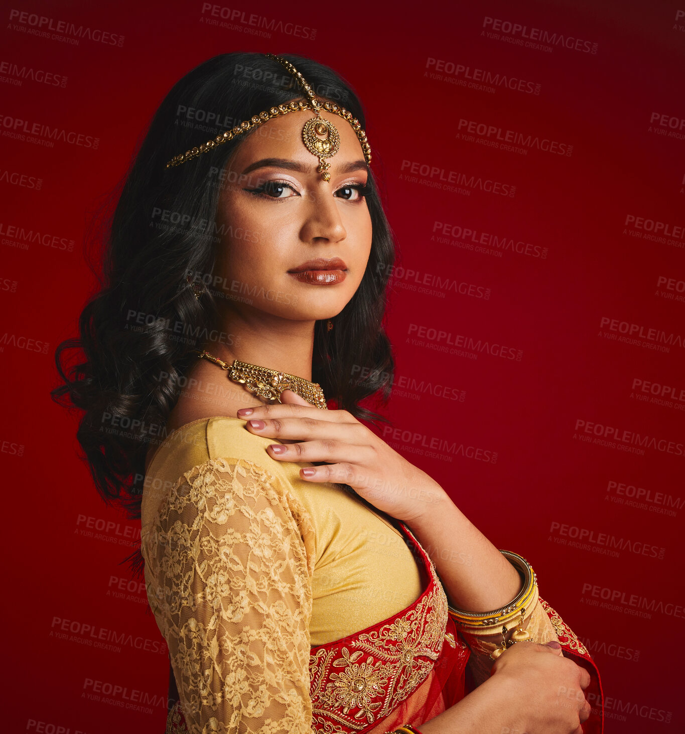 Buy stock photo Fashion, culture and portrait of Indian woman with beauty in traditional clothes, jewellery and sari. Religion, Hindu and face of female person on red background with accessory, cosmetics and makeup