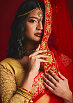 Fashion, traditional and portrait of Indian woman with veil in ethnic clothes, jewellery and sari. Religion, beauty and female person on red background with culture accessory, cosmetics and makeup