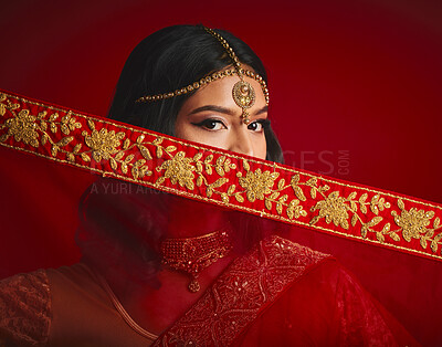 Buy stock photo Fashion, culture and portrait of Indian woman with veil in traditional clothes, jewellery and sari. Religion, beauty and eyes of female person on red background with accessory, cosmetics and makeup