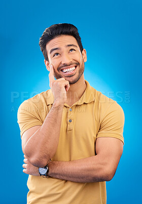 Buy stock photo Thinking, studio ideas and happy man brainstorming, inspiration plan or wonder about development. Planning, memory and Asian person smile for questions, decision or choice space on blue background