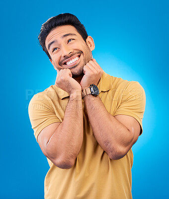 Buy stock photo Happy, smile and man in studio with a dreaming or sweet memory or future facial expression. Happiness, excited and male model from India with positive mindset for planning isolated by blue background