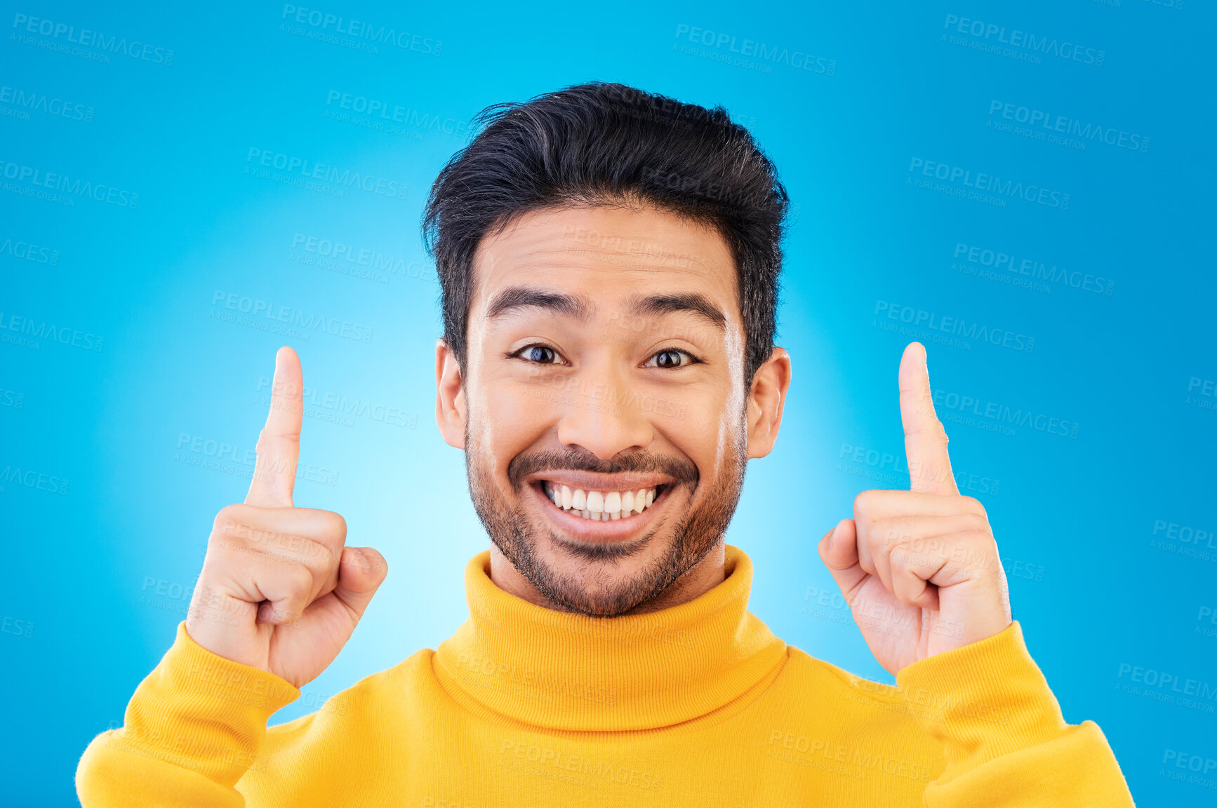 Buy stock photo Pointing up, excited and portrait of Asian man on blue background for news, announcement and information. Advertising, marketing and face of male person with hand gesture for promotion, deal and sale