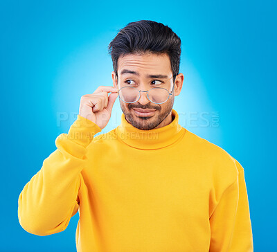 Buy stock photo Thinking, glasses and Asian man with ideas, decision and emoji against a blue studio background. Male person, model and guy with eyewear, opportunity or choice with solution, focus or problem solving