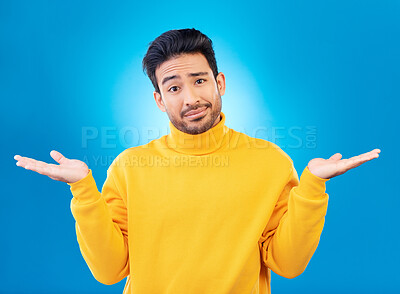 Buy stock photo Doubt, shrug and portrait of a man in a studio with a confused hand gesture and facial expression. Uncertain, choice and male model with questions or decision face isolated by a blue background.