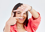 Happy, portrait of a woman with hand frame and against a studio background happy. Social media or capture, face or smile and female person pose with gesture for perfect photography in backdrop