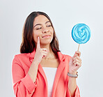 Woman, face and thinking of lollipop, candy or sweets for junk food, snack or unhealthy decision. Curious, studio or business person wonder about sugar calories, choice or dessert on white background