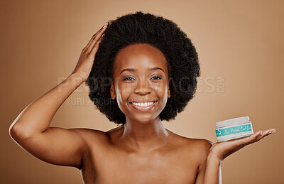 Buy stock photo Portrait, hair and curl treatment with a black woman in studio on a brown background for cosmetics. Face, smile and haircare product in the palm of a happy female model for natural afro hairstyle