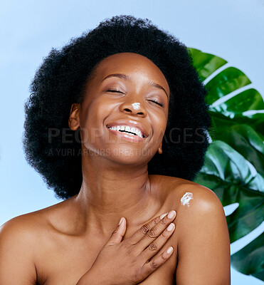 Buy stock photo Skincare, cream and woman with monstera plant for beauty, cosmetics and natural product, moisturizer or collagen. African person or model with lotion, plants and dermatology on studio blue background