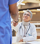 Woman, doctor and handshake with nurse for teamwork, partnership or thank you for healthcare service, meeting or hospital onboarding. Female surgeon shaking hands with nursing staff, trust or support