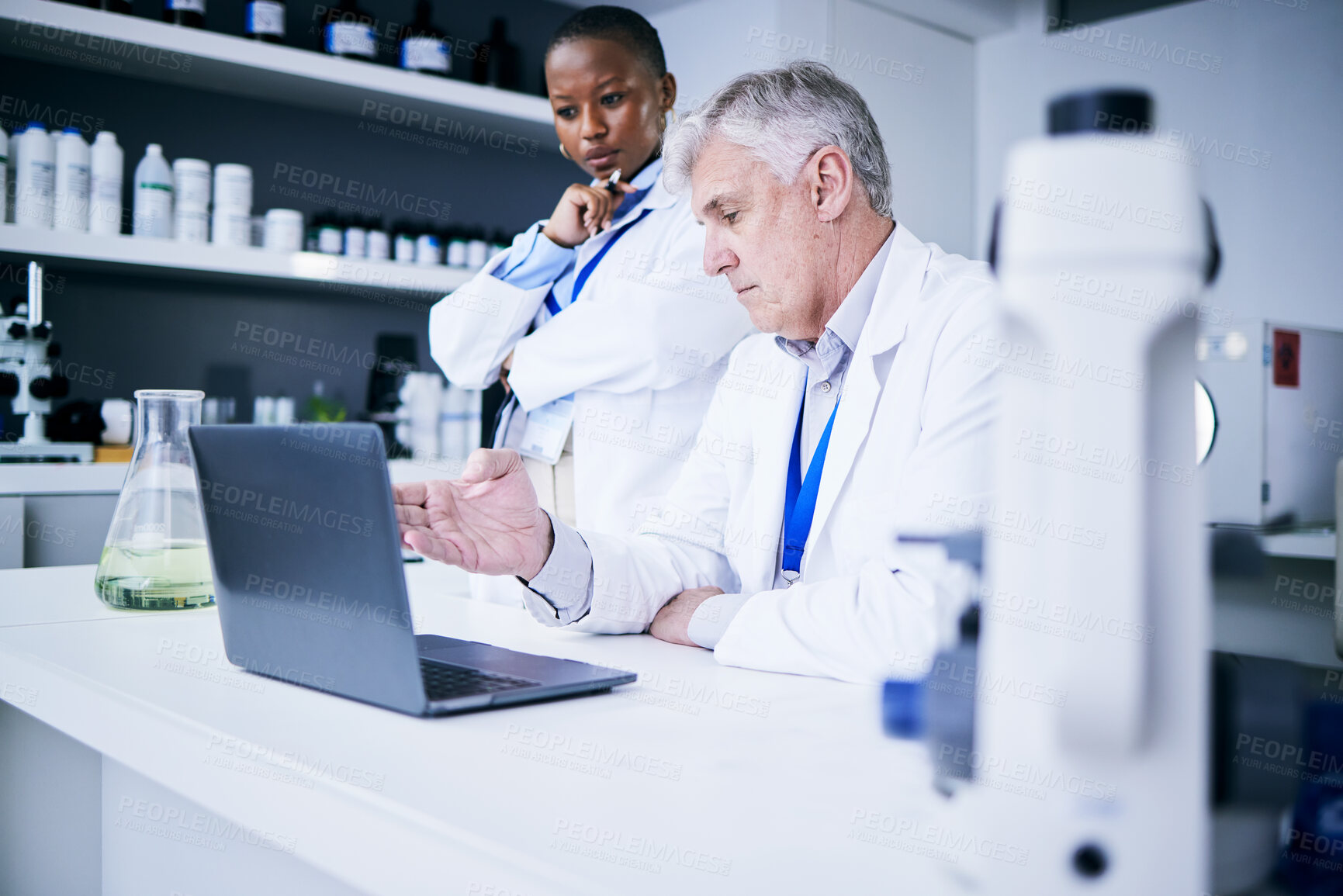 Buy stock photo Medical, man and black woman with a laptop, research or teamwork with planning, conversation or data analysis. Male person, female researcher or scientist with a pc, analytics or results with network