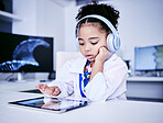 Education, headphones and black girl with elearning on tablet with childhood development. Studying, typing and tech with female child with reading for lessons with online app and software with kid.