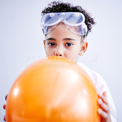 Buy stock photo Portrait, science and a kid blowing a balloon in studio on a gray background for a childhood experiment. Children, education and laboratory with a female child wearing goggles while learning