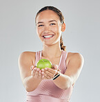 Portrait, apple and offer of woman isolated on studio, white background for healthy food, healthcare or nutritionist diet. Face of vegan person or model giving green fruit for diet, care and choice