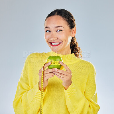 Buy stock photo Tape measure, apple and portrait of woman with fruit in studio for healthy eating, wellness and balance diet. Vegan, lose weight and female person on white background with food for nutrition or detox