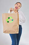 Recycling, environment and happy woman with bag, carbon footprint and sustainability with shopping on white background. Environmental, retail and eco friendly, female person excited in studio