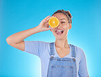 Portrait, tongue out and woman with orange in studio isolated on a blue background. Face, fruit and person with food for healthy diet, nutrition or wellness, eating and vitamin c, benefits and vegan.