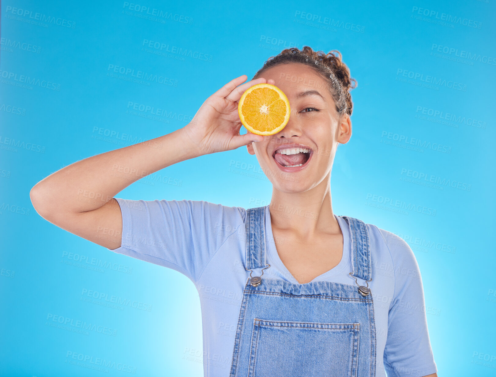 Buy stock photo Portrait, tongue out and woman with orange in studio isolated on a blue background. Face, fruit and person with food for healthy diet, nutrition or wellness, eating and vitamin c, benefits and vegan.