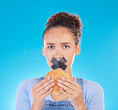 Buy stock photo Burger, diet and woman reject fast food choice and unhappy gives bad, disgust and frustrated review for protection. Disaster, mistake and person disappointed isolated in a studio blue background