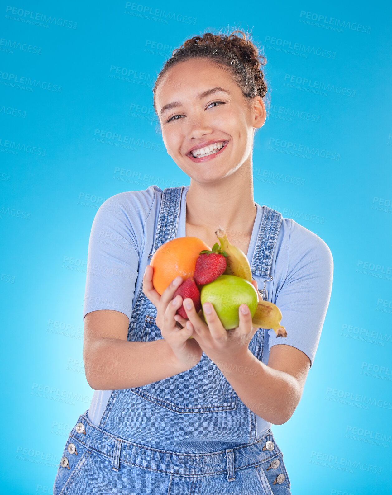 Buy stock photo Happy, diet and portrait of woman with fruit in studio for healthy eating, wellness and wellbeing. Food, lose weight and female person on blue background with apple, orange and banana for nutrition