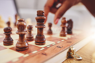Buy stock photo Chess, game and closeup of hand with board moving piece for strategy, thinking and challenge. Competition, winning and zoom of hands of person with chessboard in living room for playing to checkmate