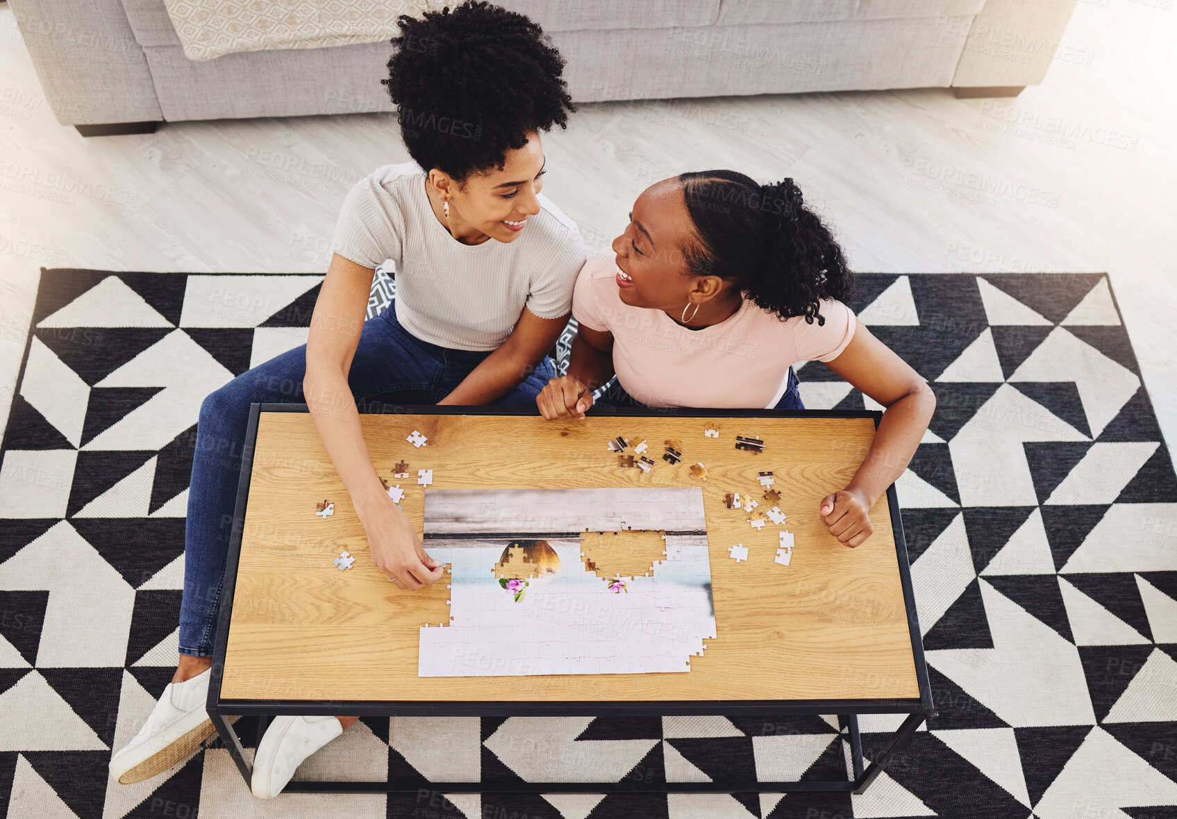 Buy stock photo Puzzle, friends together and game in living room for fun, bonding or quality time of playing from above girls in house. Women, jigsaw and people happy to connect pieces on table in family home