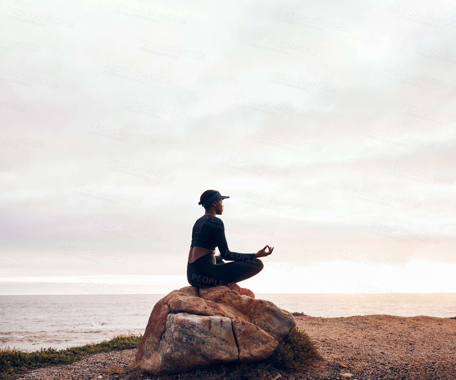 Buy stock photo Lotus pose, woman and yoga at the beach, fitness and meditation with spiritual wellness in nature. Exercise, zen and female yogi on rock outdoor with holistic healing and calm, sea and mindfulness