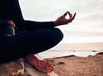 Lotus pose, hands and yoga at the beach, fitness and meditation, spiritual wellness with person in nature. Exercise, zen and yogi on rock outdoor with holistic healing and calm, sea and mindfulness