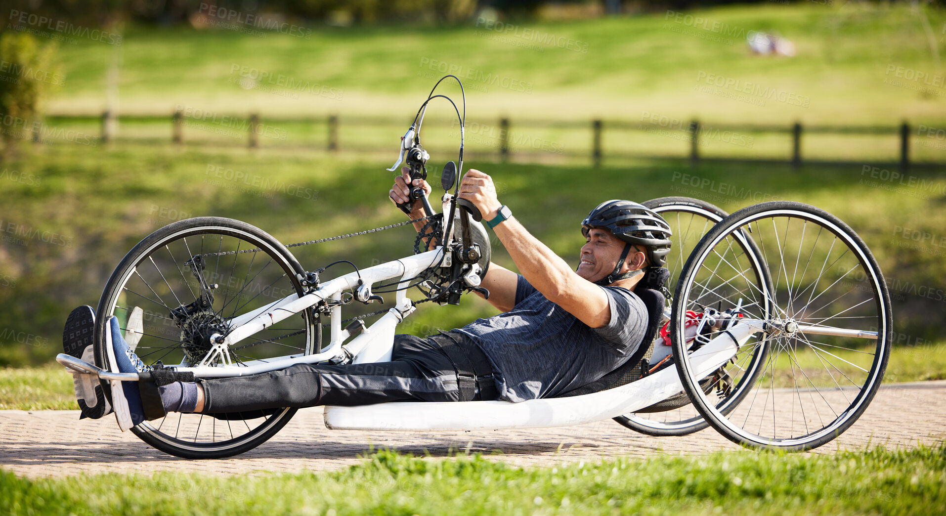 Buy stock photo Cycling, fitness and health with man and handcycle in nature for training, sports and challenge. Exercise, workout and wellness with person with a disability in park for cardio and bicycle marathon