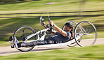 Cycling, disability and fast with man and bike with handicap for training, sports and challenge. Exercise, workout and wheelchair with disabled person training in park for cardio and health