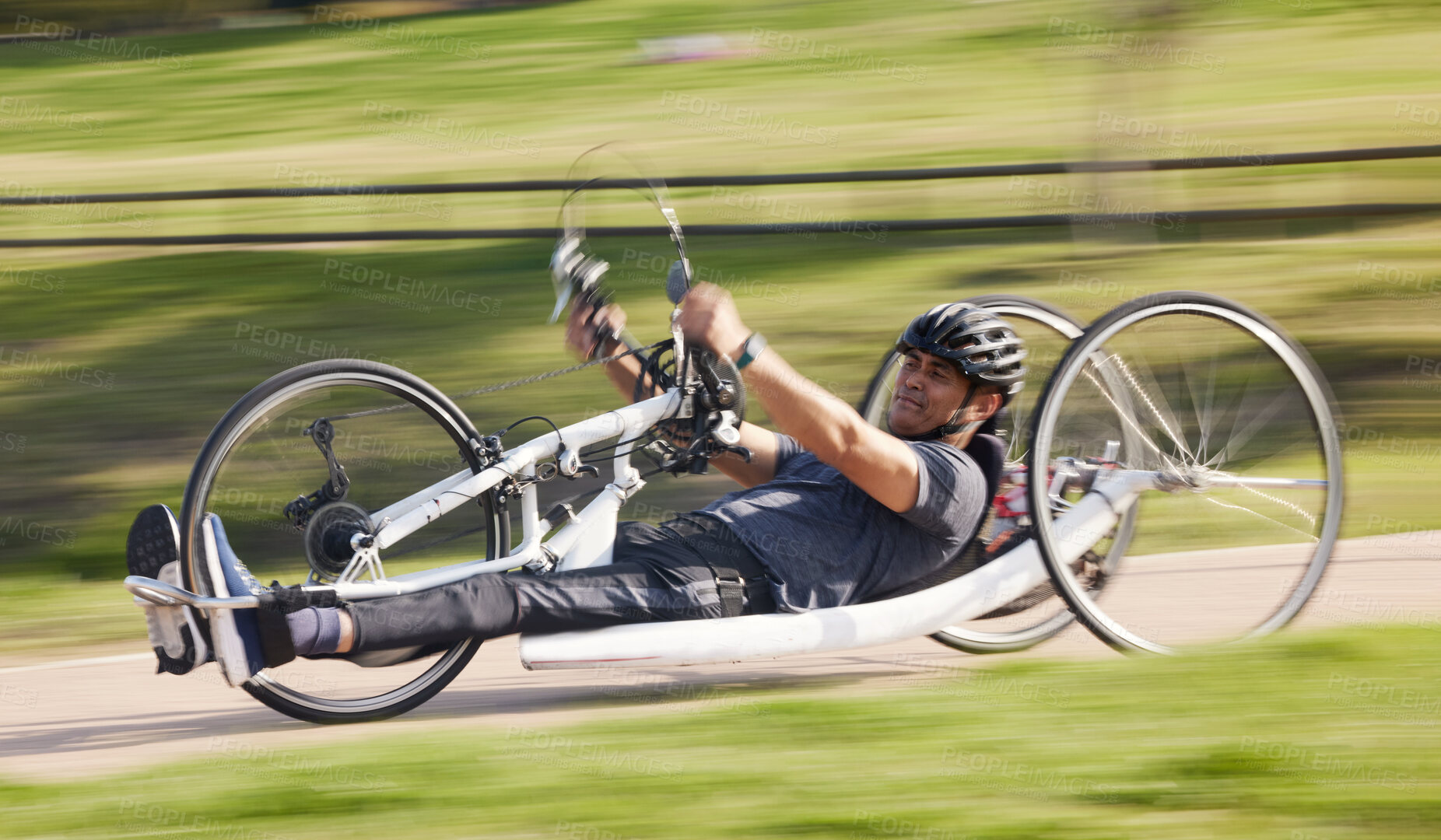 Buy stock photo Cycling, fitness and fast with man and handcycle in nature for training, sports and challenge. Exercise, workout and cardio with person with a disability in park for motion blur, marathon and health