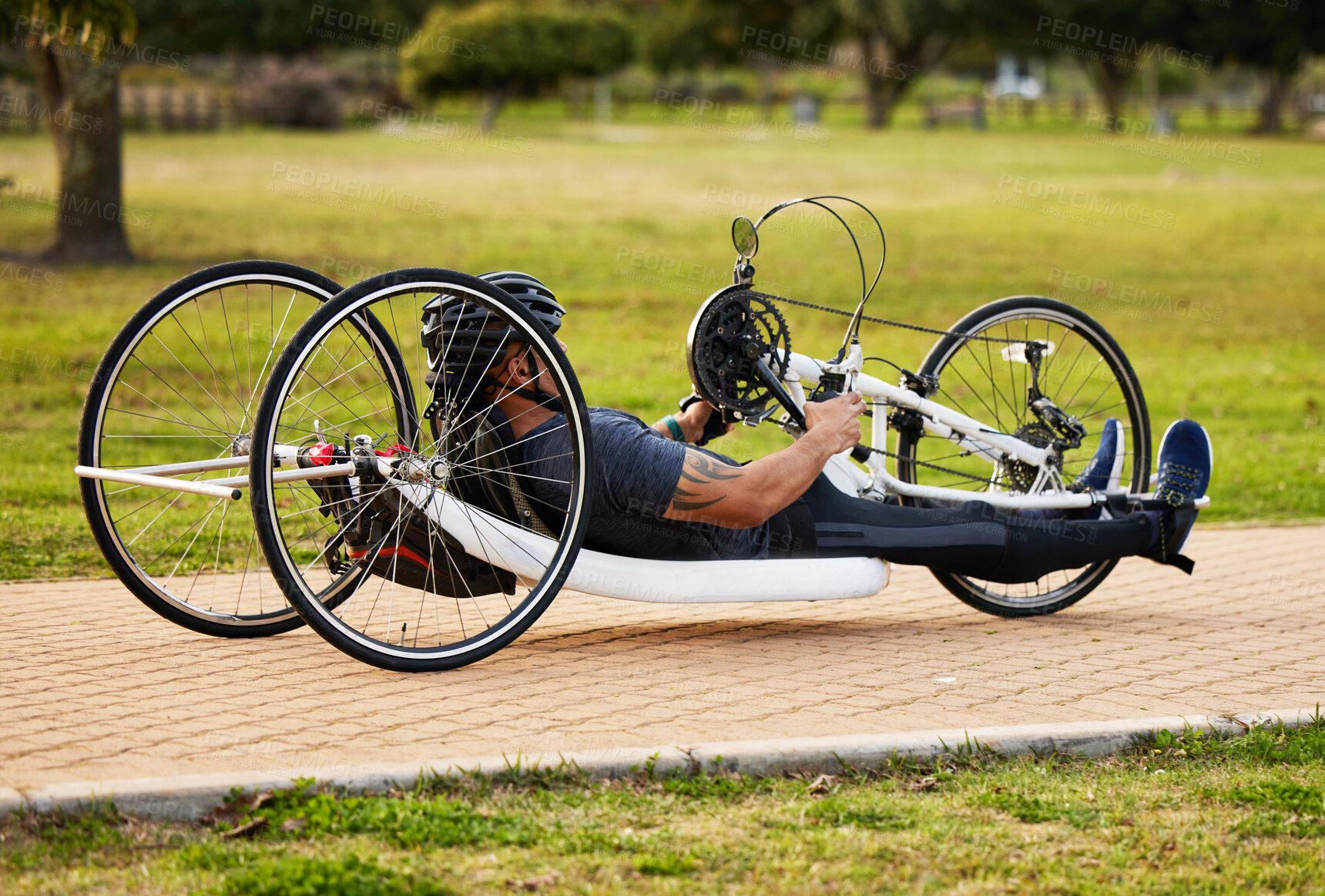 Buy stock photo Health, cycling and fitness with man and handcycle on road for training, sports and challenge. Exercise, workout and marathon with person with a disability in park for cardio and wellness