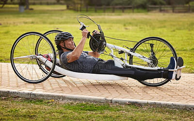 Buy stock photo Cycling, sports and fitness with man and handcycle on road for training, bike and challenge. Exercise, workout and marathon with person with a disability riding in park for cardio and health
