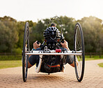 Disability, bicycle and paraplegic person cycling as morning exercise, workout or training for wellness and health. Handbike, sports and person on a wheelchair bike training strength and endurance
