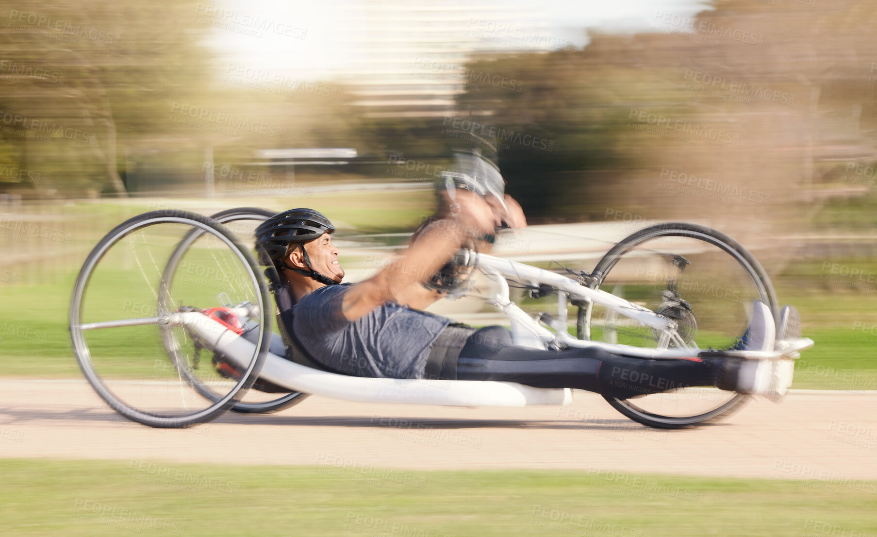 Buy stock photo Cycling, speed and man with disability in race training for competition with action, motivation and exercise on bike. Energy, workout and person on recumbent bicycle on fast outdoor track challenge.