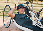 Sports, athlete or a man with a disability and bike for handicap race, fitness and recumbent challenge. Exercise, happy and a handbike of Paralympic person outdoor for cycling or cardio for training