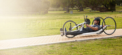 Buy stock photo Cycling, fitness and space with man and handcycle in nature for training, sports contest and challenge. Exercise, workout and banner with person with a disability in park for cardio and health mockup