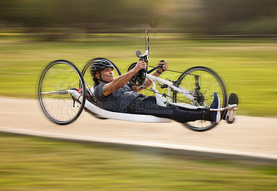 Buy stock photo Cycling, fitness and fast with man and handcycle in nature for training, sports and challenge. Exercise, workout and motion blur with person with a disability in park for cardio and health on road