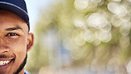 Portrait, mockup and blurred background with a man in nature, outdoor during summer for adventure. Half face, smile and green space with a happy young male person wearing a cap during the day