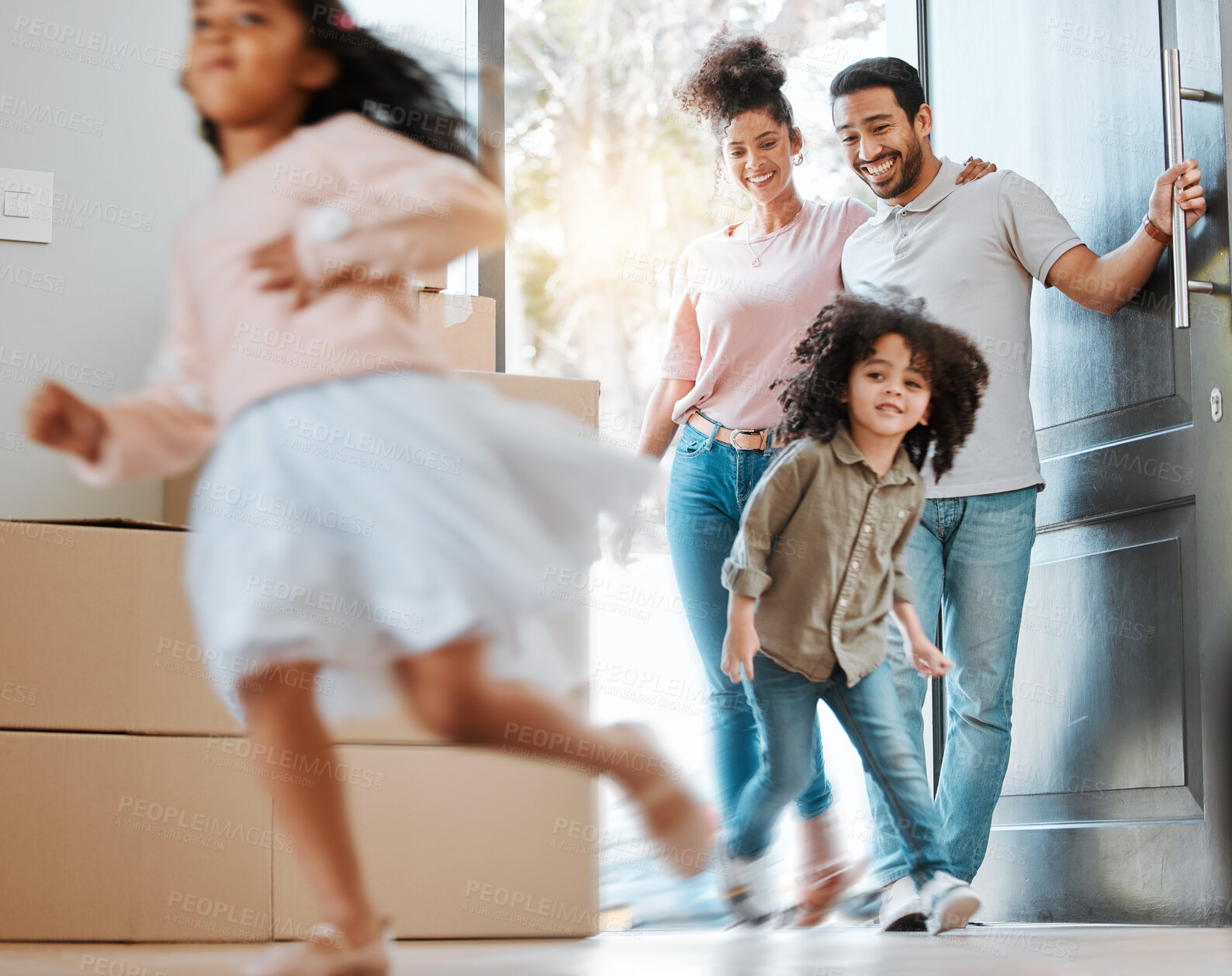 Buy stock photo Happy, moving and parents with children running in their new modern family house with excitement. Happiness, smile and young mother and father watching their kids jumping in blur motion at their home