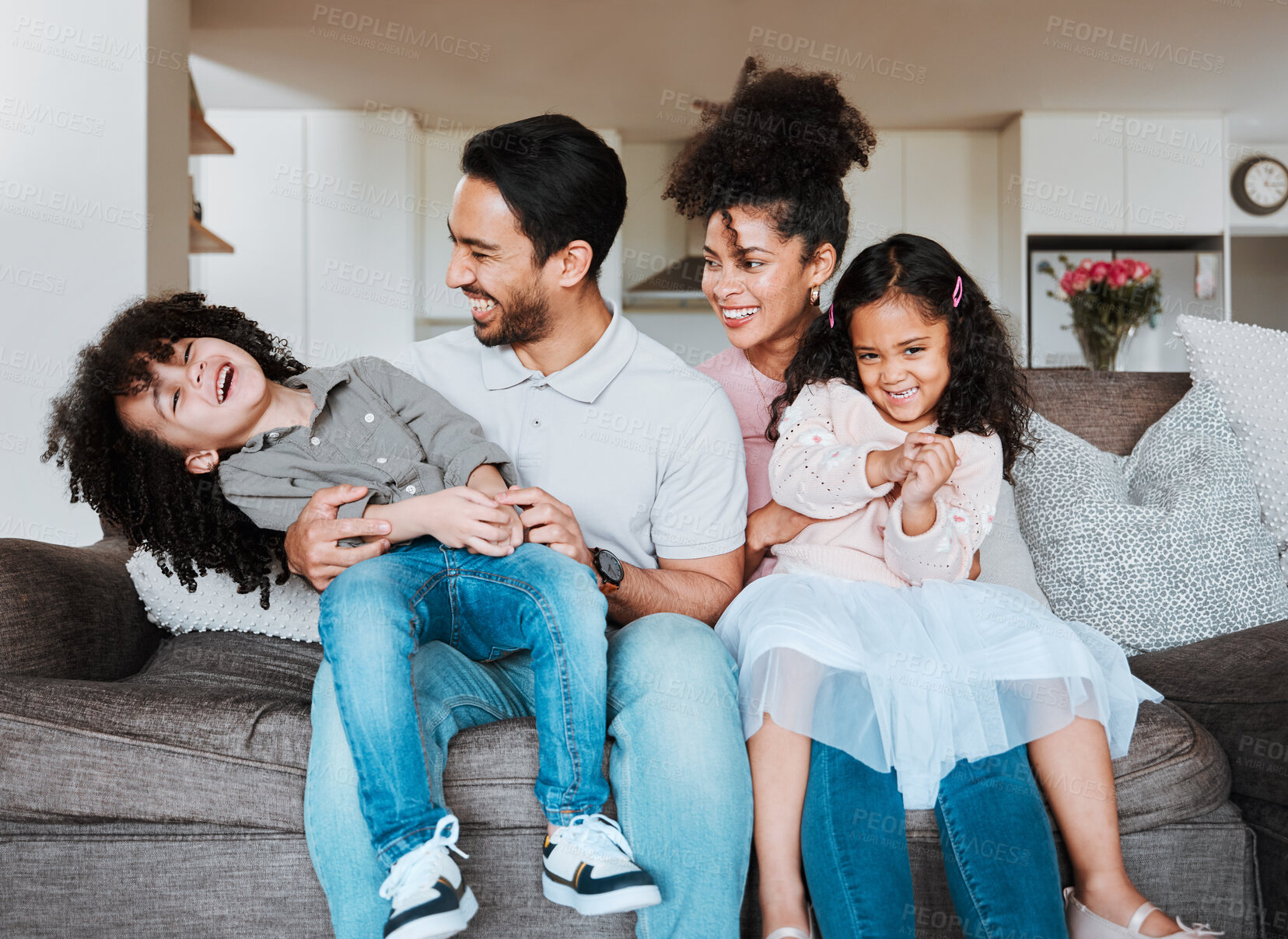 Buy stock photo Mom, dad and children on sofa, playing and happy family bonding together in living room in Mexico. Smile, happiness and parents relax with kids on couch, quality time and fun in new home or apartment