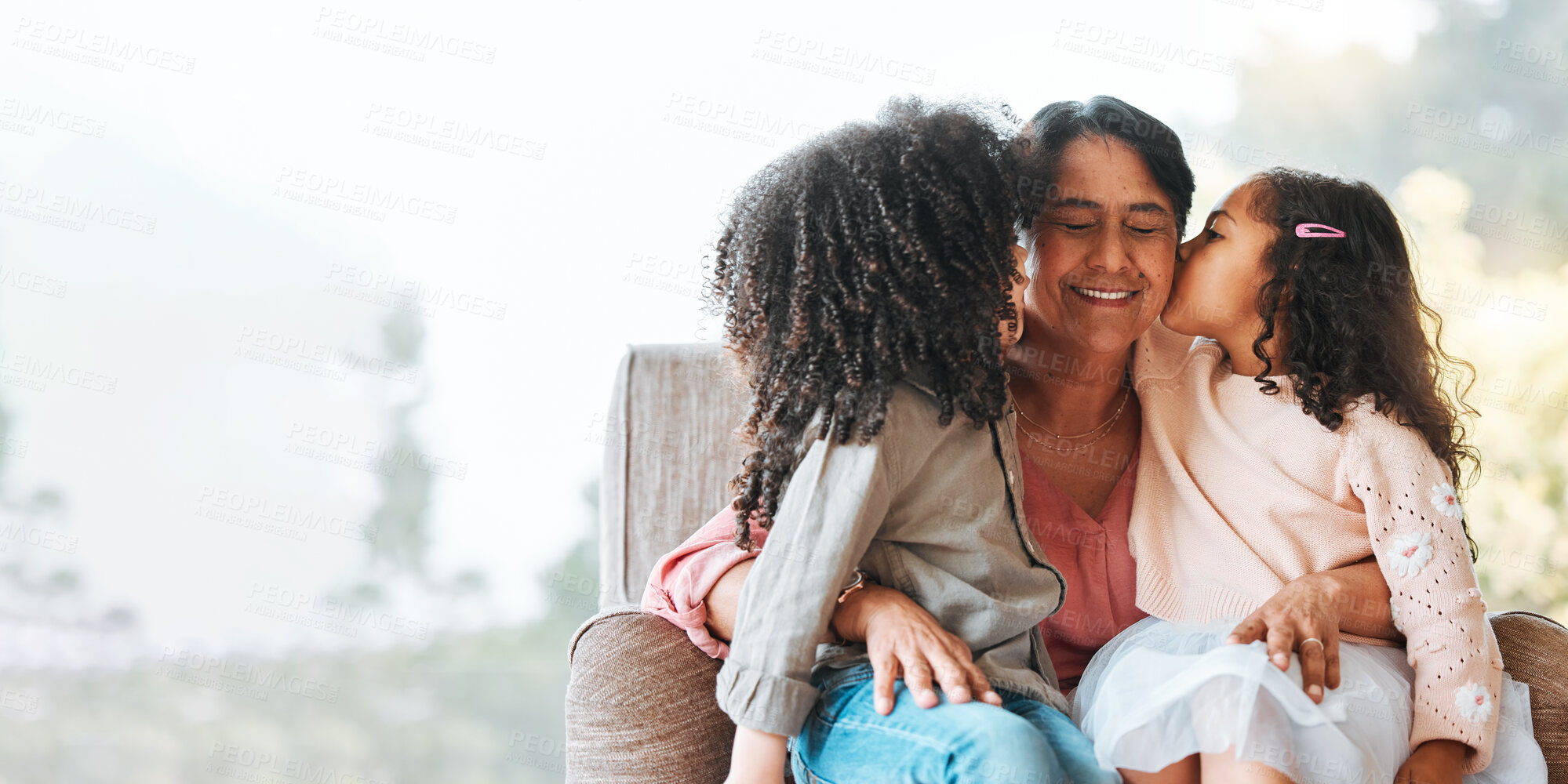 Buy stock photo Family, kiss and grandmother with children on a sofa happy, sweet and bond in their home. Love, kissing and senior woman with girls kids in living room hug, having fun and enjoying weekend together